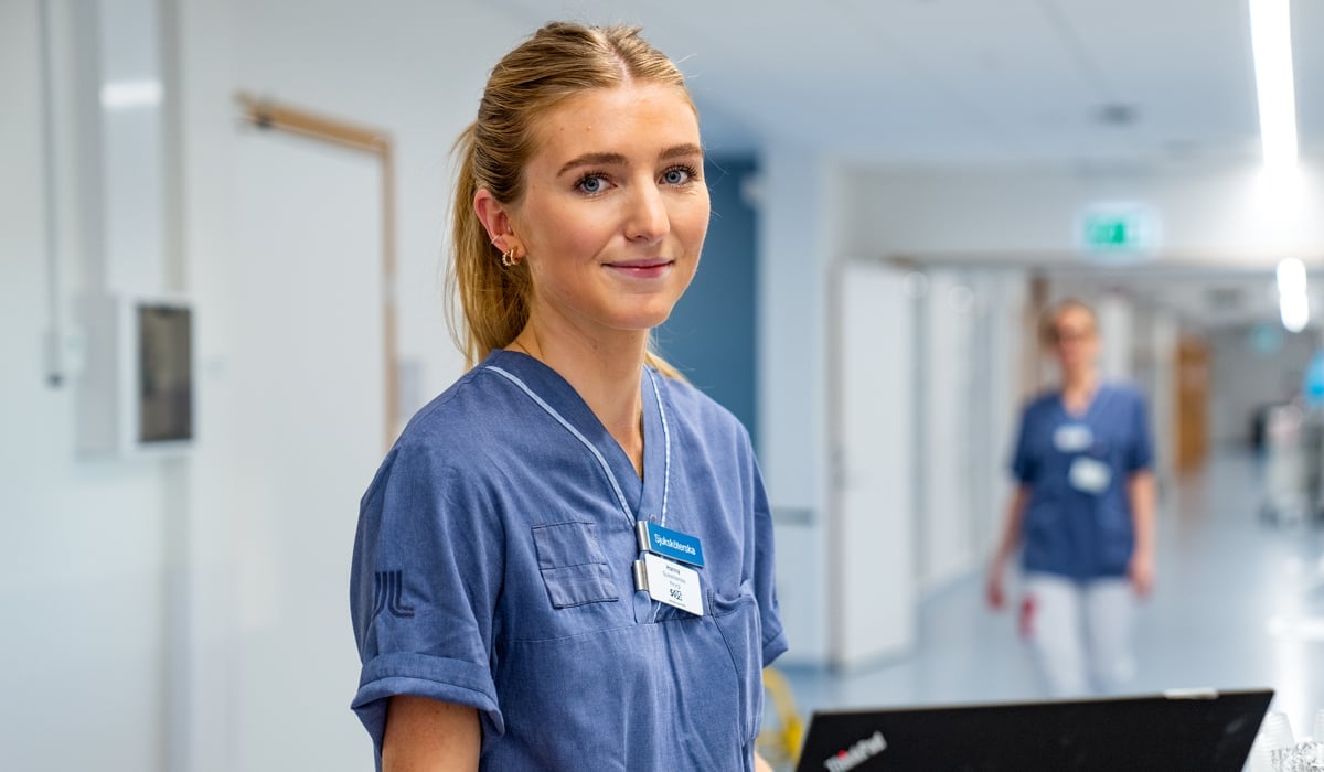 Bild på en sjuksköterska som står vid en dator